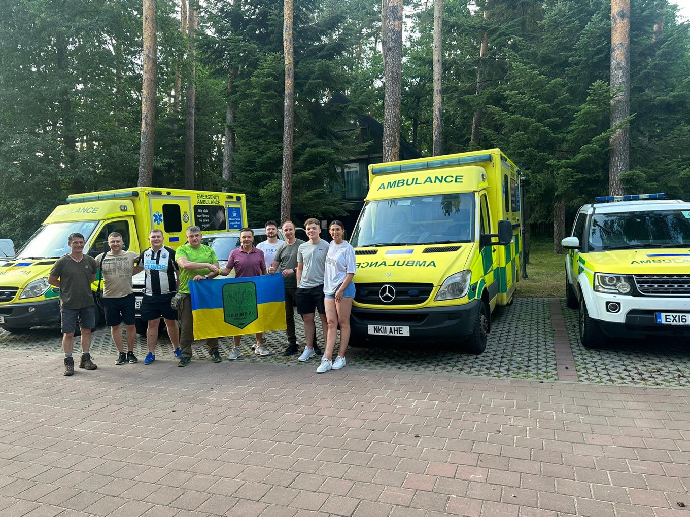 The team with the vehicles as they meet friends on their journey..jpg