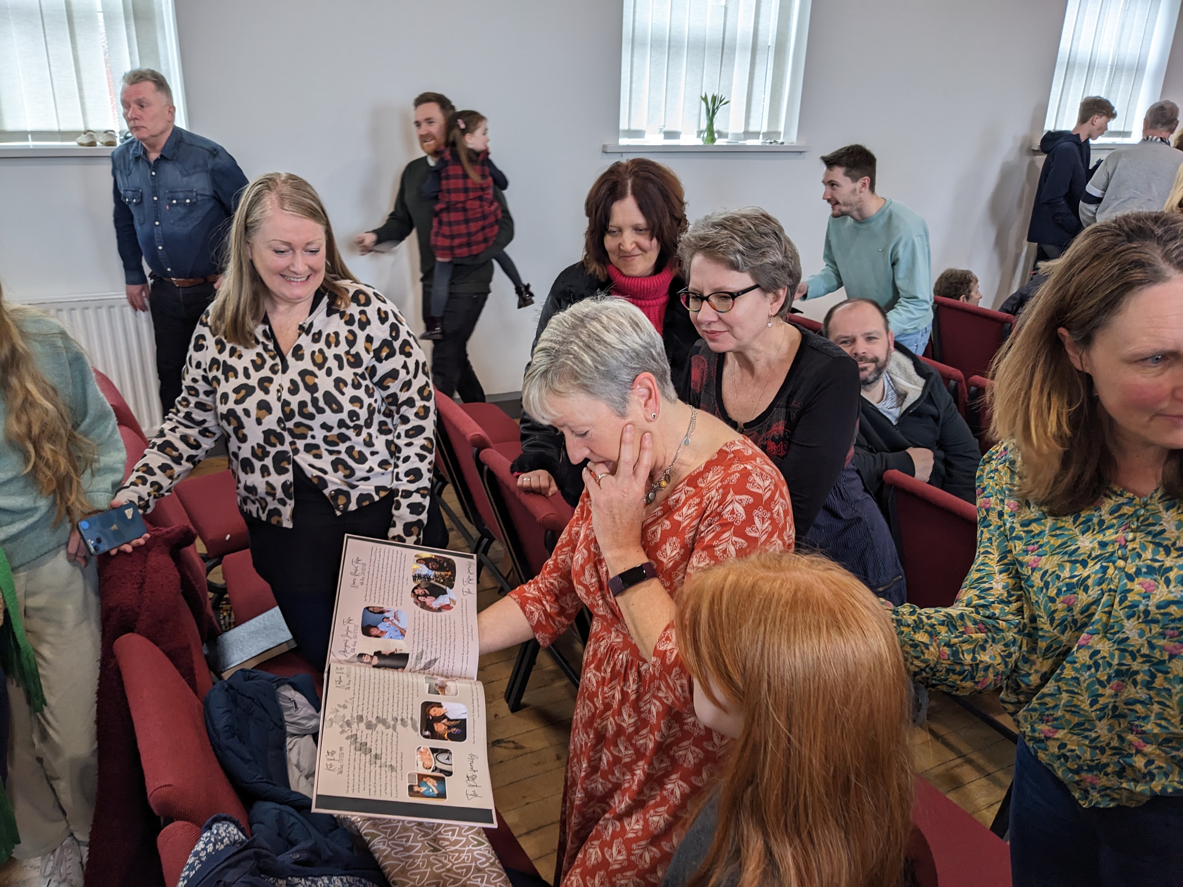 Lynn Metcalfe looking through the book presented to her by her church..jpg