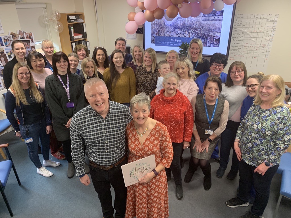 Lynn Metcalfe and husband Gary with some of her maternity colleagues as they celebrated her retirement..png